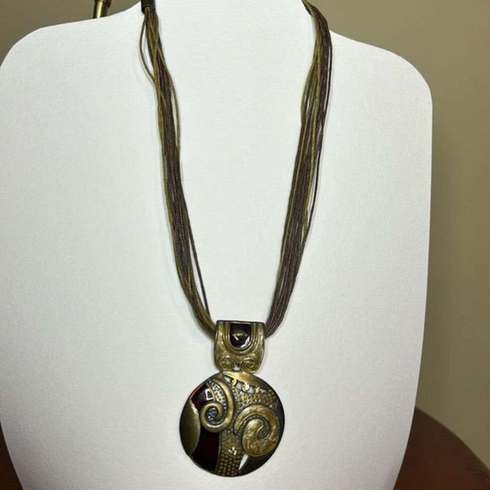 Brown/Bronze swirl pendant‎ with rhinestones on a multi corded necklace